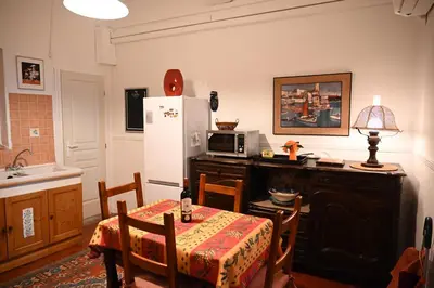 a kitchen with a table and a refrigerator at Family Apartment 2BR Old Town near Beach AC in Nice
