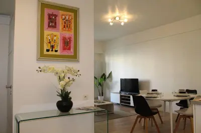 a living room with a table and a dining room at Nice Plein Centre, Calme et Proche de la mer in Nice