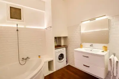a white bathroom with a sink and a washing machine at Nice Plein Centre, Calme et Proche de la mer in Nice