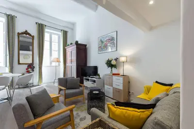 a living room with a couch and a tv at BARILLERIE - Loft Moderne, Face Mer, Vieux-Nice. in Nice