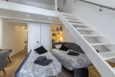 a room with two beds and a staircase at BARILLERIE - Loft Moderne, Face Mer, Vieux-Nice. in Nice