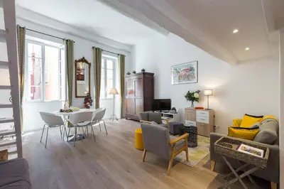 a living room with a couch and a table at BARILLERIE - Loft Moderne, Face Mer, Vieux-Nice. in Nice