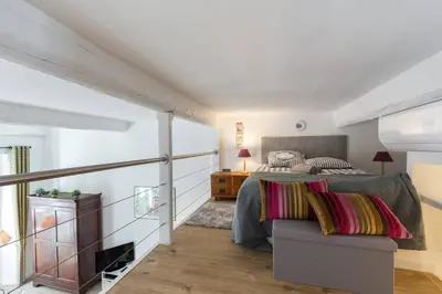 a bedroom with a bed and a couch at BARILLERIE - Loft Moderne, Face Mer, Vieux-Nice. in Nice