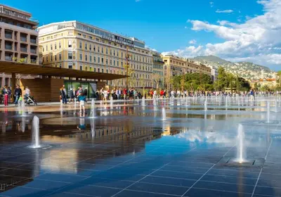 a group of people walking around a fountain in a city at BARILLERIE - Loft Moderne, Face Mer, Vieux-Nice. in Nice