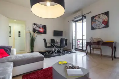a living room with a couch and a table at GRAND H -F2, FACE VIEUX- NICE, TERRASSE, ASCENSEUR, CLIMATISATION, Terrace - Nice city center in Nice