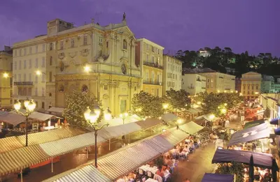 a city street at night with a large building at GRAND H -F2, FACE VIEUX- NICE, TERRASSE, ASCENSEUR, CLIMATISATION, Terrace - Nice city center in Nice
