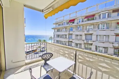 a balcony with a table and chairs and a view of the ocean at PROMENADE HOLIDAY - PALATIN & SEA in Nice
