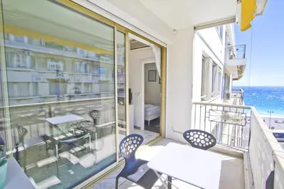 a balcony with a table and chairs and the ocean at PROMENADE HOLIDAY - PALATIN & SEA in Nice