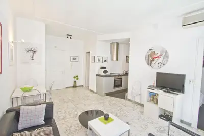 a living room with a couch and a tv at PROMENADE HOLIDAY - PALATIN & SEA in Nice