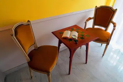 two chairs and a table with two books on it at Nestor&Jeeves - DEBUSSY TERRASSE - Central - By shopping area in Nice