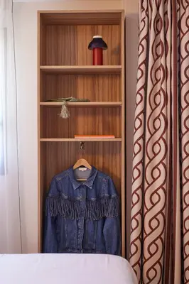 a wooden closet with a denim shirt in it at Hotel Restaurant Isidore by Soniho in Nice