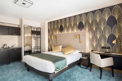 a bedroom with a bed and a desk and a kitchen at Best Western Hôtel Journel Saint-Laurent-du-Var Aéroport in Saint-Laurent-du-Var