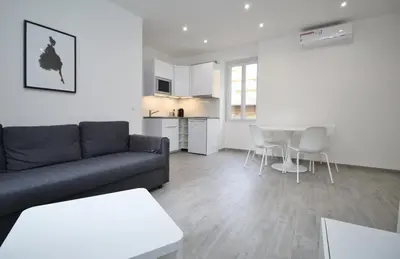 a living room with a couch and a table at Republique Garibaldi in Nice