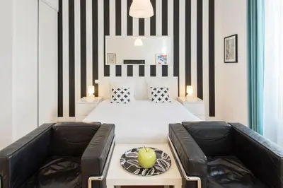 a bedroom with a bed with black and white stripes at Le Studio Graphite Welkeys in Nice