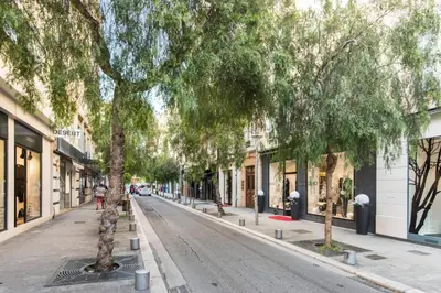 a tree lined street in a city with buildings at Le Studio Graphite Welkeys in Nice