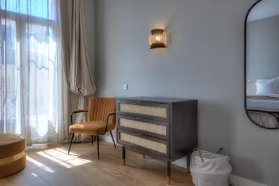 a bedroom with a dresser and a chair and a mirror at Maison Lamartine - Nice in Nice