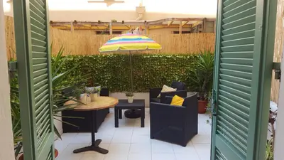 a patio with a table and an umbrella at Nice France in Nice