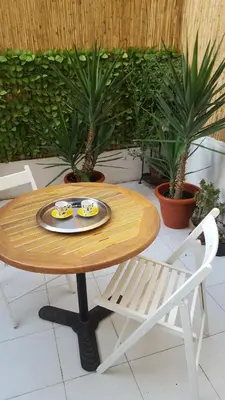 a table with a plate of food and a chair at Nice France in Nice