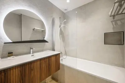 a bathroom with a sink and a mirror at Hotel De La Darse in Villefranche-sur-Mer