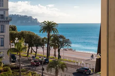 a view of a beach and the ocean from a building at Prestige Apartment, near the beaches in Nice