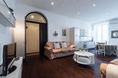 a living room with a couch and a table at Prestige Apartment, near the beaches in Nice