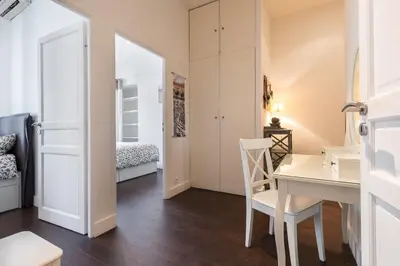 a small apartment with a desk and a bedroom at Prestige Apartment, near the beaches in Nice