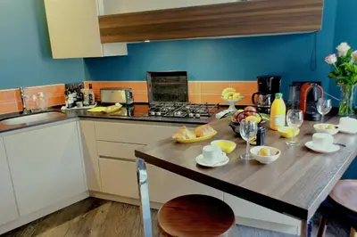 a kitchen with a wooden table with fruit on it at Ze Perfect Place - Élégant appartement avec terrasse - Promenade des Arts in Nice