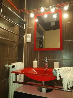 a bathroom with a red sink and a mirror at Les Pieds dans l'Eau in Nice