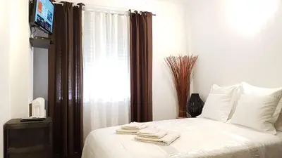 a bedroom with a bed with towels on it at Les Pieds dans l'Eau in Nice