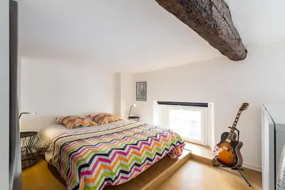a bedroom with a bed and a guitar in it at Nicelidays - Le Suede - Carré d'or - 2min from beaches in Nice
