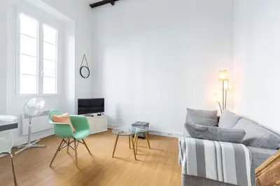 a living room with a couch and a table and chairs at Nicelidays - Le Suede - Carré d'or - 2min from beaches in Nice