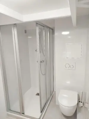 a white bathroom with a shower and a toilet at Nicelidays - Le Suede - Carré d'or - 2min from beaches in Nice