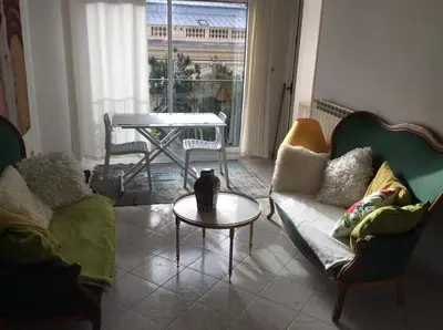 a living room with a couch and a table at Les Grands Cedres D3 in Nice