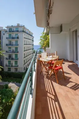 a balcony with a table and chairs on a building at le capitole in Nice