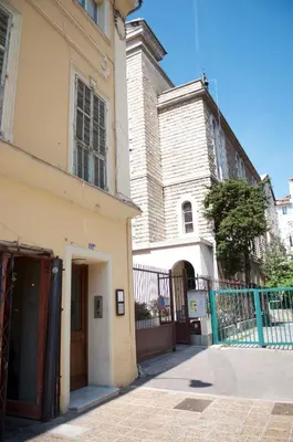 a building with a gate next to a church at AzurAppart Elegant Studio Centre in Nice