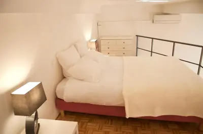 a bedroom with a bed with white sheets and pillows at AzurAppart Elegant Studio Centre in Nice