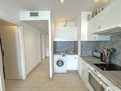 a kitchen with a washer and a washing machine at PROMENADE HOLIDAY - ROYAL LUXEMBOURG PROMENADE in Nice