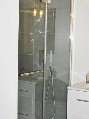 a shower with a glass door in a bathroom at Sam Le Lezard Sarl in Nice