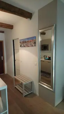 a room with a bench and a mirror at Sam Le Lezard Sarl in Nice