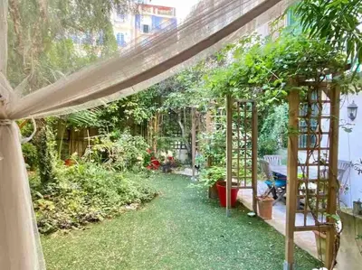 a garden with a pergola and some plants at Homelivia, Luxueux Appartement avec Jardin privé in Nice