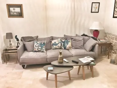 a living room with a couch and a table at Homelivia, Luxueux Appartement avec Jardin privé in Nice