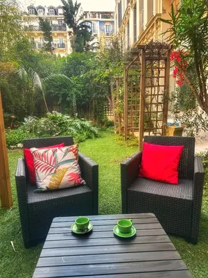 two chairs and a table with green cups on it at Homelivia, Luxueux Appartement avec Jardin privé in Nice