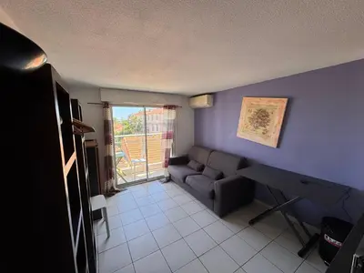a living room with a couch and a table at Nice Sunshine in Nice