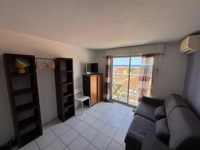 a living room with a couch and a balcony at Nice Sunshine in Nice