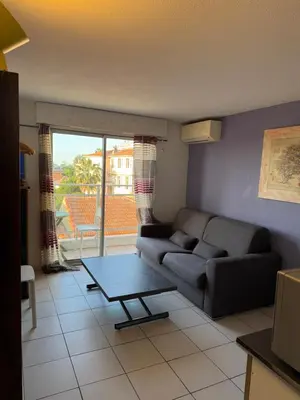 a living room with a couch and a table at Nice Sunshine in Nice