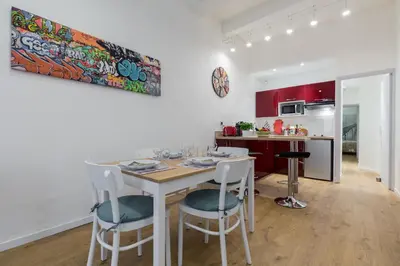 a kitchen and dining room with a table and chairs at Large one bedroom flat in the Old Town in Nice