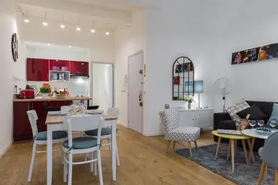 a kitchen and living room with a table and chairs at Large one bedroom flat in the Old Town in Nice