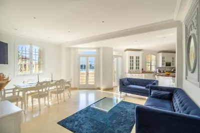 a living room with two blue couches and a table at Semiramis in Villefranche-sur-Mer