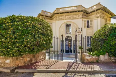 a large house with a gate in front of it at Semiramis in Villefranche-sur-Mer