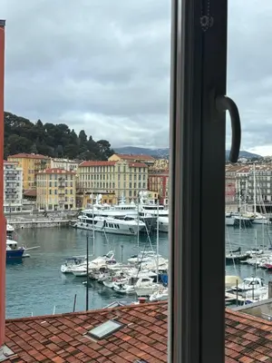 a view of a harbor with boats in the water at Nice Port, French Riviera in Nice